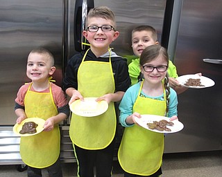 Neighbors | Zack Shively.The children got to choose whether they wanted to decorate three suckers or one chocolate bunny at the Sugar Showcase's Easter event. Pictured are Travis Pittman, Easton Pittman, Colton Bond and Makenzie Bond as they wait to decorate their sweets.