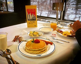 "Dinner (or breakfast) in the diner, nothing could be finer" as the song goes.  This, however, could be changing on two Amtrak trains that pass through northeast Ohio as Amtrak has announced to cut the traditional dining car from the trains.  

Here, in this March 5, 2016 photo, breakfast is served on the westbound Capitol Limited en route to Chicago in a sit-down, restaurant style setting.  

Photo by Scott Williams - The Vindicator