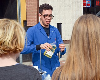 Salam Pickard, a YSU chemistry student, performs an experiment at the Federal Frenzy Music and Arts Festival on West Federal Street in downtown Youngstown on Saturday, April 21, 2018.  

Photo by Scott R. Williams - The Vindicator