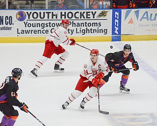 Flying puck!  Youngstown Phantom's #62, Michael Joyaux, and #19, Chase Gresock, and Dubuque Fighting Saints #24, Josh Maniscalco, and #7, Jacob Semik, try to follow the puck as it is flying through the air during the second game of the USHL playoff at the Covelli Center on Saturday, April 21, 2018.  

Photo by Scott Williams - The Vindicator