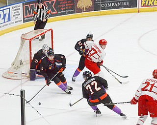 Youngstown Phantom #5, Jason Smallidge, gets the puck away from their net as Phantoms #52, Craig Needham, and Phantoms #72, Liam Dennison, keep Dubuque Fighting Saints #17, Tyce Thompson, and #21, Alex Steeves, respectively, back as well during the second game of the USHL playoff at the Covelli Center on Saturday, April 21, 2018.  

Photo by Scott Williams - The Vindicator.