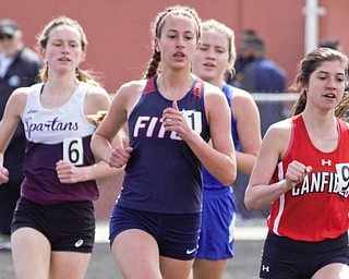Lauren Dolak of Austintown Fitch, center, attempts to outduel Ashley Ventimiglia of Canfield, right, and Casey Zaitzew of Boardman, left, as Gianna Stanich of Poland, back, also tries to stay with the leaders at the Mahoning County Track and Field Championships on Saturday at Fitch High School. 