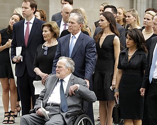 Former Presidents George H.W. Bush and George W. Bush accompanied by their family members watch as pallbearers carry the casket of former first lady Barbara Bush after a funeral service Bush at St. Martin's Episcopal Church, Saturday, April 21, 2018, in Houston. (AP Photo/Evan Vucci)