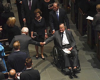 Former President George H.W. Bush exits the funeral of his wife Barbara Bush, followed by his daughter-in-law former first lady Laura Bush and son former President George W. Bush, at St. Martin's Episcopal Church, in Houston, Saturday, April 21, 2018  (Jack Gruber /USA Today via AP, Pool)