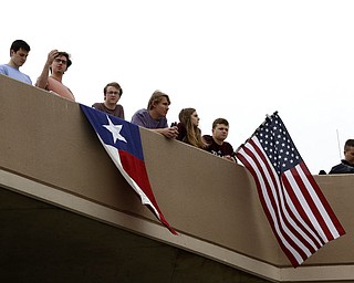 People line up on the top of a parking garage to pay tribute as they wait for the motorcade carrying former first lady Barbara Bush on George Bush Drive, Saturday, April 21, 2018, in College Station, Texas. (AP Photo/Mark Humphrey)