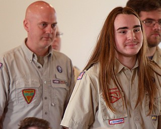 William D. Lewis The Vindicator  Isaac Coxson, 18, and member of Troop 55 of Youngstown is followed by his scoutmaster Rick Cook Jr. into Eagle Scout Court of Honor at Corner House Christian Church in Hubbard 4-22-18. Coxson was awarded his Eagle  during the event..