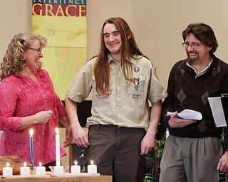 William D. Lewis The Vindicator Isaac Coxson, 18, member of Boy Scout Troop 55 of Youngstown gets congrats ffrom his parents Rev. David Coxson and Kim Coxson after recieving his Eagle .Scout award at a court of honor at Cornerhouse Christian Church in Hubbard where his father is pastor. Isaac's Eagle service project was collecting more than 20 musical instruments for the HubbardHS band of which he is a member.