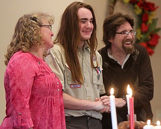 William D. Lewis The Vindicator Isaac Coxson, 18, member of Boy Scout Troop 55 of Youngstown gets congrats ffrom his parents Rev. David Coxson and Kim Coxson after recieving his Eagle .Scout award at a court of honor at Cornerhouse Christian Church in Hubbard where his father is pastor. Isaac's Eagle service project was collecting more than 20 musical instruments for the HubbardHS band of which he is a member.