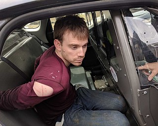 Travis Reinking appears here in custody in photos released via Twitter by Nashville Metro Police.