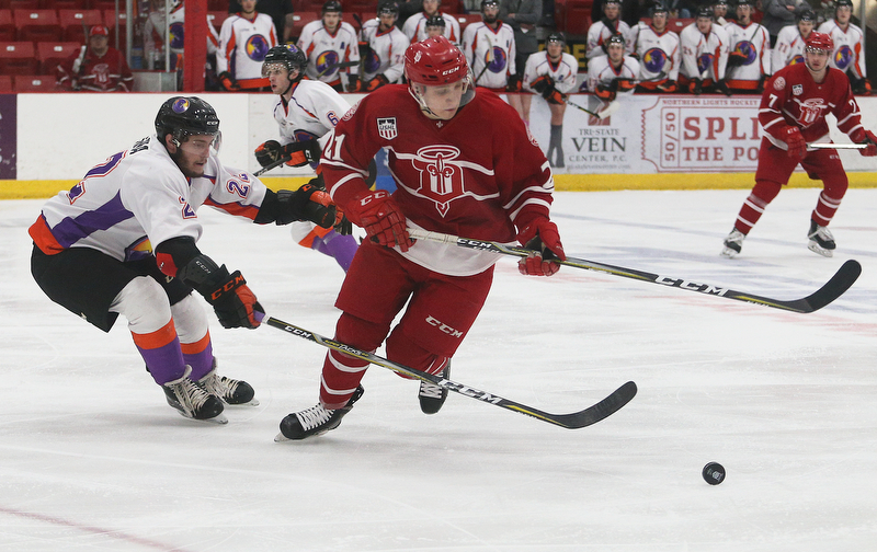 Dubuque Fighting Saints' Alex Steeves (right) tries to get around Youngstown Phantoms' Dalton Messina during their hockey game at Mystique Community Ice Center in Dubuque on Tuesday, April 24, 2018.