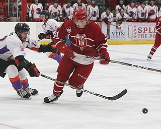 Dubuque Fighting Saints' Alex Steeves (right) tries to get around Youngstown Phantoms' Dalton Messina during their hockey game at Mystique Community Ice Center in Dubuque on Tuesday, April 24, 2018.