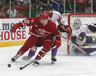 Dubuque Fighting Saints' Tyce Thompson tries to protect the puck from Youngstown Phantoms' Jack Malone during their hockey game at Mystique Community Ice Center in Dubuque on Tuesday, April 24, 2018.