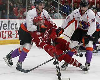 Youngstown Phantoms' Jack Malone (left) and Curtis Hall (right) knock Dubuque Fighting Saints' Tyce Thompson off his feet during their hockey game at Mystique Community Ice Center in Dubuque on Tuesday, April 24, 2018.