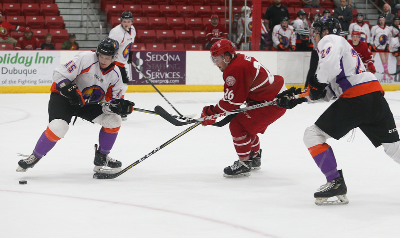 Dubuque Fighting Saints' Jan Kern (center) tries to get past Youngstown Phantoms' Jake Gingell (left) and Steve Holtz during their hockey game at Mystique Community Ice Center in Dubuque on Tuesday, April 24, 2018.
