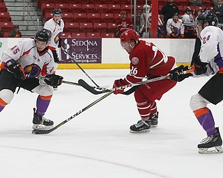 Dubuque Fighting Saints' Jan Kern (center) tries to get past Youngstown Phantoms' Jake Gingell (left) and Steve Holtz during their hockey game at Mystique Community Ice Center in Dubuque on Tuesday, April 24, 2018.