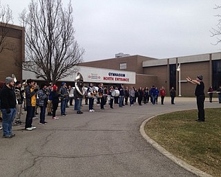 Neighbors | Submitted .In spite of unseasonable weather, the Austintown Fitch High School band practices outside of Fitch High School to prepare for the National Cherry Blossom Parade in Washington D.C. Pictured is Band Director Wesley O’Connor leading the practice.
