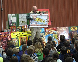 Neighbors | Zack Shively."Buck Wilder" author Tim Smith writes and illustrates his books. He showed the Dobbins Elementary students a sample drawing from a book that demonstrated his style of placing words sideways or upside-down.