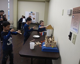 Neighbors | Zack Shively.The children at the "It's a Royal Affair" library program played a number of games, including a ringtoss and beanbag toss game, a ball toss game and a catapult game where the children launched small pompoms at a small castle.