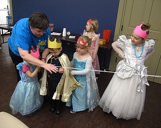 Neighbors | Zack Shively.The Boardman library does many children events with different themes. The medieval theme allowed them to play a number of different games and hear interesting stories about knights and kingdoms. Pictured, librarian Karen Saunders helped a child make a Rapunzel braid or fishing line out of yarn.