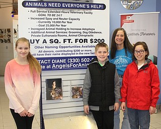 Neighbors | Abby Slanker.With the help of Angels for Animals co-founder Diane Less (back), Canfield Village Middle School Ambitious Citizens for Empathy Charity Committee members , from left, Emily Heino, Matthew Logan and A.J. Helmick decided to buy two of the 1-square-foot blocks in the new Angel Wing building with money they raised and donated to the organization on March 31. Missing from photo is committee member Anna Kerns.