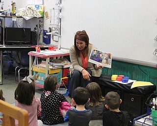Neighbors | Abby Slanker.C.H. Campbell Elementary School kindergarten teacher Tammy Sabrin read a book to kindergartners and their families during the school’s Literacy Night.