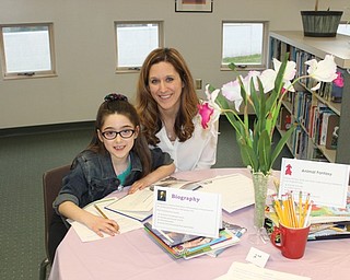 Neighbors | Abby Slanker.Second-grader Giuliana Sebastiani and her mother, Michelle, visited the Book Tasting in the library during the school’s Literacy Night.