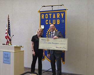 Neighbors | Zack Shively.The Night at the Races and the Chili Open allowed the Poland Rotary to give $25,000 back to the community. Pictured is Kelly Long of Walnut Grove and Rotary President Dan Madden. Walnut Grove will use the funds to continue to build their inclusive playground for both children with and without disabilities.