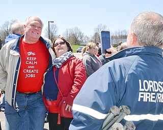 Eric Wishart, right, takes a photo of Angela Wishart with Lordstown Mayor Arno Hill at a rally to keep TJX in the Mahoning Valley on Sunday, April 29, 2018 at the Lordstown High School track.  

Photo by Scott R. Williams - The Vindicator