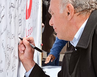 Trumbull County Commissioner Frank S. Fuda signs his name to a banner in support of TJX at a rally to keep TJX in the Mahoning Valley on Sunday, April 29, 2018 at the Lordstown High School track. 

Photo by Scott R. Williams - The Vindicator