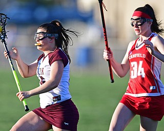 BOARDMAN, OHIO - APRIL 30, 2018: Boardman's Paige Jankowski drives to the goal on Canfield's Lily Pollen during the first half of their game on Monday night at Spartan Stadium. DAVID DERMER | THE VINDICATOR