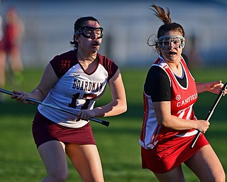 BOARDMAN, OHIO - APRIL 30, 2018: Canfield's Isabella Kelty drives to the goal on Boardman's Emily Jackson during the first half of their game on Monday night at Spartan Stadium. DAVID DERMER | THE VINDICATOR