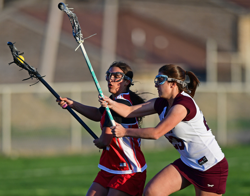 BOARDMAN, OHIO - APRIL 30, 2018: Canfield's Athena Poullas drives to the goal on Boardman's Lily Essad during the first half of their game on Monday night at Spartan Stadium. DAVID DERMER | THE VINDICATOR