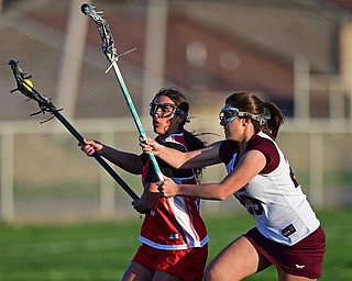 BOARDMAN, OHIO - APRIL 30, 2018: Canfield's Athena Poullas drives to the goal on Boardman's Lily Essad during the first half of their game on Monday night at Spartan Stadium. DAVID DERMER | THE VINDICATOR
