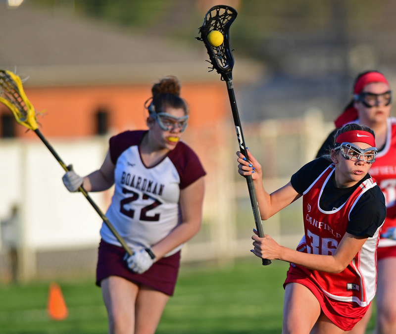 BOARDMAN, OHIO - APRIL 30, 2018: Canfield's Tara Santoro goes to the net after getting behind Boardman's Abigail Serrino during the first half of their game on Monday night at Spartan Stadium. DAVID DERMER | THE VINDICATOR