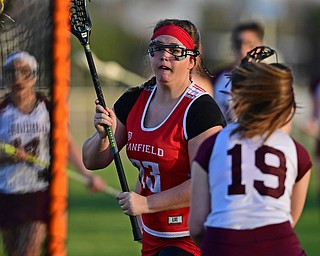 BOARDMAN, OHIO - APRIL 30, 2018: Canfield's Geena Cianciolla shoots and scores while being pressured by Boardman's Colleen Yambar during the first half of their game on Monday night at Spartan Stadium. DAVID DERMER | THE VINDICATOR