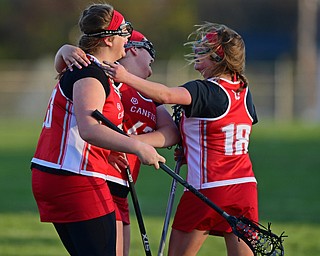BOARDMAN, OHIO - APRIL 30, 2018: Canfield's Geena Cianciolla, left, is congratulated by her teammates Shiane Donnarummno and Hannah Crowe after scoring a goal during the first half of their game on Monday night at Spartan Stadium. DAVID DERMER | THE VINDICATOR