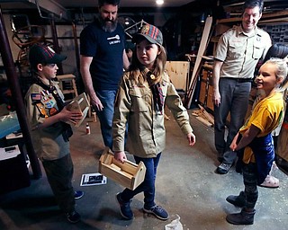 In this March 1, 2018, file photo, Tatum Weir, center, carries a tool box she built as her twin brother Ian, left, follows after a Cub Scout meeting in Madbury, N.H. Fifteen communities in New Hampshire are part of an “early adopter” program to allow girls to become Cub Scouts and eventually Boy Scouts. For 108 years, the Boy Scouts of America’s flagship program for older boys has been known simply as the Boy Scouts. With girls soon entering the ranks, the BSA says that iconic name will change to “Scouts BSA.” The change will take effect in February 2019.