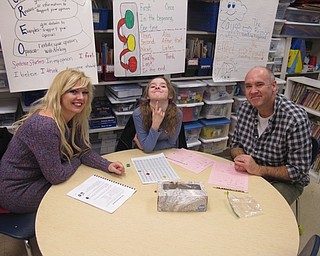 Neighbors | Zack Shively.The families had three stations, including one that demonstrated the workplace activities the students do each day. These activities are math-based games that reinforces the students learning. Pictured, Michele, Sylvia and David Simonelli played a counting game.