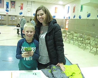 Neighbors | Zack Shively.In the gymnasium of Union Elementary, principal Michael Masucci gave the families plants to work on the students' measurement and data skills. Pictured are Jaxon and Tiffiny Vesey.