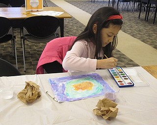 Neighbors | Zack Shively.The Austintown library had their "Detectives Wanted" program on April 17. The event included a number of activities for children focused on a detective theme. Pictured, Shaylee Nolan used invisible ink to make a design in her painting.