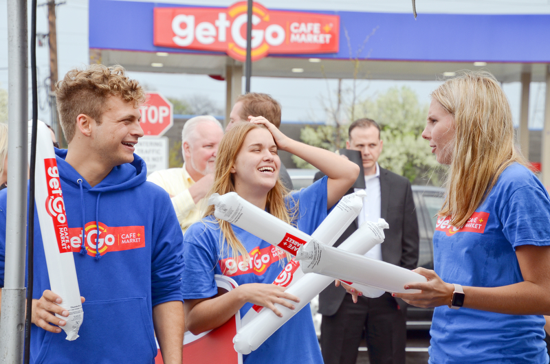 From left to right, Zachary Carels, Julie Bowser, and Georgia Fowkes pass out some blown up noise makers at the grand-opening ceremony of the new GetGo gas station/cafe/market at 133 Boardman-Poland Road in Boardman on Thursday May 3, 2018.  

Photo by Scott Williams - The Vindicator