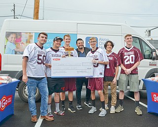 GetGo presented the Boardman High School Boys Lacrosse team with a check for $1,500 at the grand-opening ceremony of the new GetGo gas station/cafe/market at 133 Boardman-Poland Road in Boardman on Thursday May 3, 2018. From left to right is #50 - Cody Geary, #9 - Devin Whitaker, #55 - Clayton Wehr, Adam Richman - celebrity chef, #25 - Jett Ventresco, #1 - Colin Frost, and #20 - Mitchell Brunko. 

Photo by Scott Williams - The Vindicator.