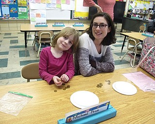 Neighbors | Zack Shively.Part of Market Street Elementary's math curriculum is playing math-based games. The teachers taught the parents some of these games at the math night so they could play educational games with their children at home. Pictured, Scarlett and Alina Hake played game centered on counting.
