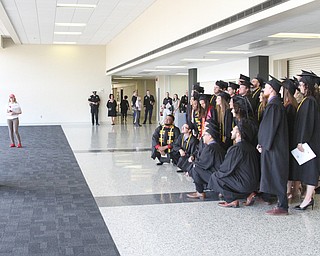 William D. Lewis The Vindicator  Frank Bosso, a professor of Sports Science at YSU stands ona trash can to take a photo of some of his graduating students before 5-5-18 commencement.