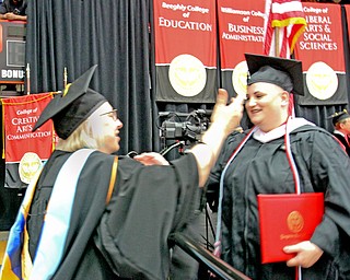 William D. Lewis The Vindicator Mary Yacovone, Program director in Respirtory Care at YSU hugs her daughter Cara Yacovone who recieved a masters in history during 5-5-18 commencement. The Yacovones are from Austintown.