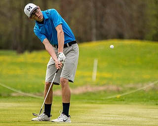 THE VINDICATOR | DIANNA OATRIDGEÊ Zavier Bokan, 17, of McDonald, chips onto the No. 1 green at Pine Lakes Golf Club on Sunday during the first qualifier of the Greatest Golfer of the Valley competition..