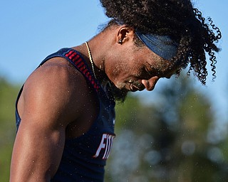 BOARDMAN, OHIO - MAY 8, 2018: Fitch's Deondre McKeever shakes the sand from his hair and face after competing int he boys long jump during the AAC Red Tier Track Championship at Boardman High School, Tuesday night. DAVID DERMER | THE VINDICATOR