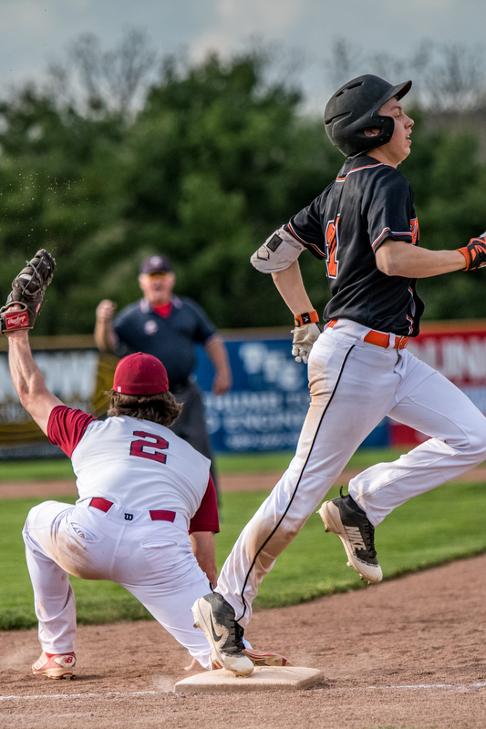 THE VINDICATOR | DIANNA OATRIDGEÊ Cardinal Mooney's first baseman Anthony Potesta makes the catch to force out Howland's Frankie Manios during their Division II Sectional Final tournament game at Cene Park on Wednesday. Mooney won 11-2.