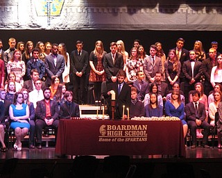 Neighbors | Zack Shively.Each of Boardman High School's new inductees to the National Honor Society walked to a front table, lit a candle and returned to their seat. Pictured, James Baker lit his candle.