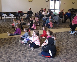 Neighbors | Zack Shively.The "Gotta Move Story Time" featured numerous dances and movement activities as well as a story. Pictured, the children at the program sat and listened to the story "Pete the Catand His Four Groovy Buttons“ written by Eric Litwin and illustrated by James Dean.